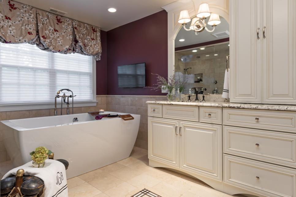 elegant burgundy bathroom features freestanding bathtub