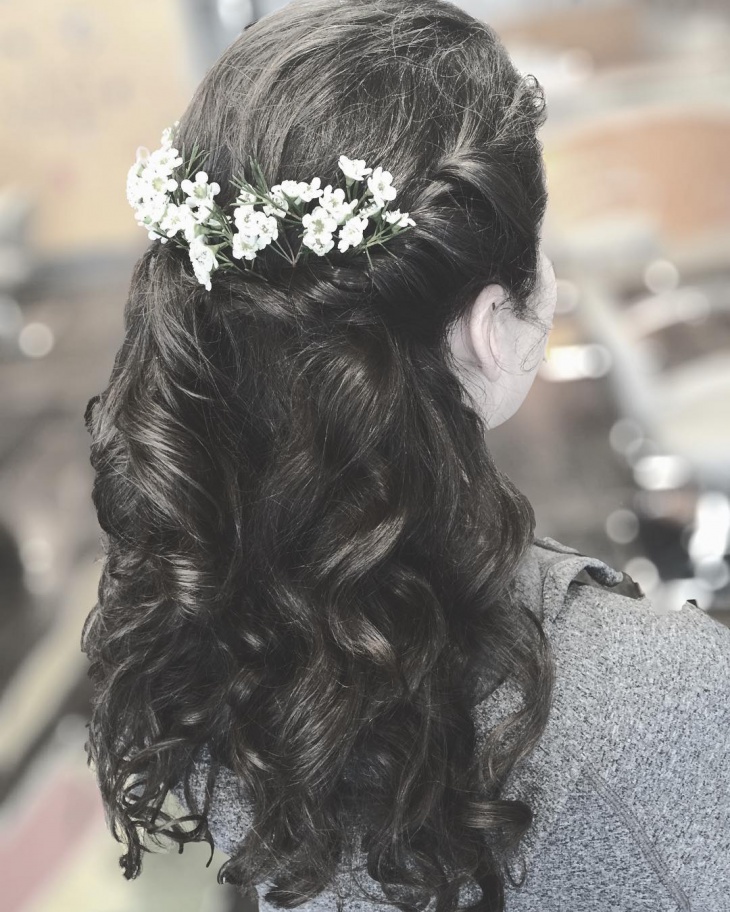 curly hair with flowers hairstyle