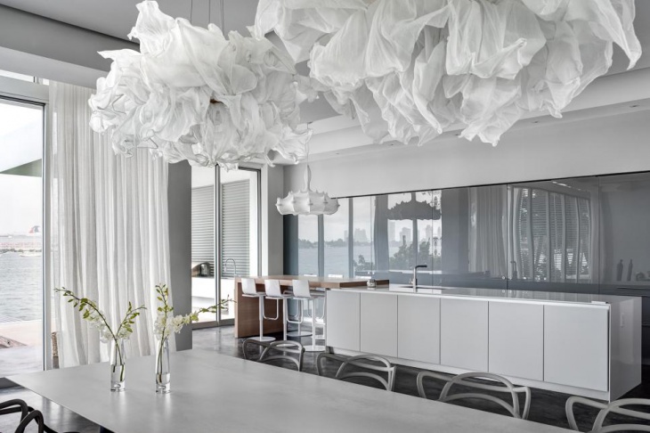 white modern dining room with cloud pendants