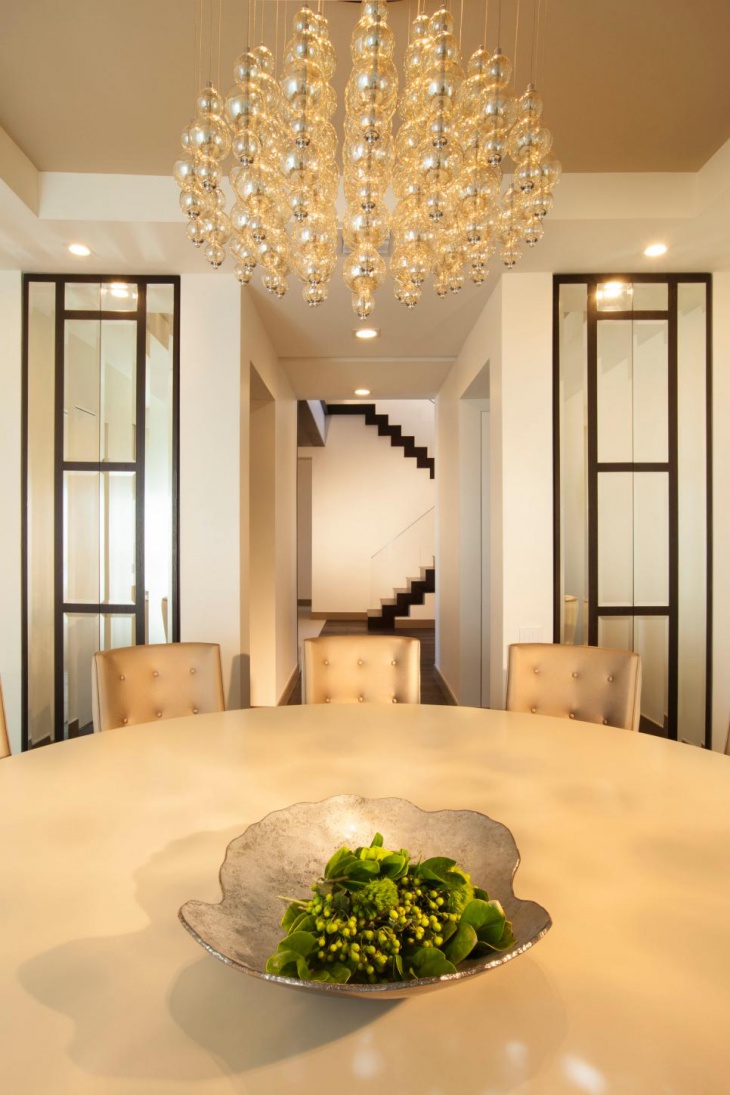 contemporary dining room with metallic pendant chandelier