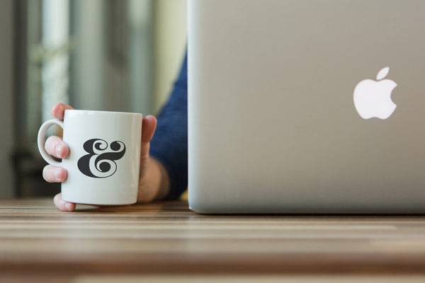 psd coffee cup mockup with macbook
