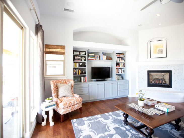 transitional white living room with built in storage