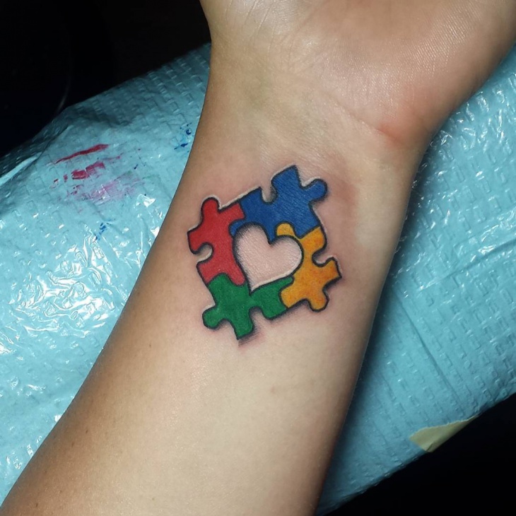 colorful puzzle piece wrist tattoo