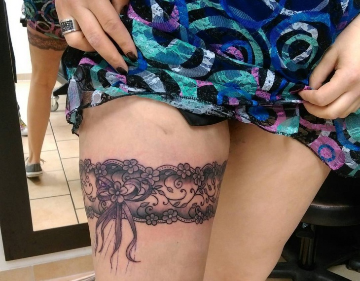 flower with ribbon leg tattoo