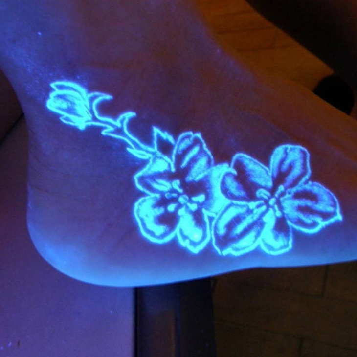 glow in the dark foot floral tattoo