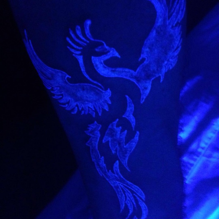 peacock back light tattoo
