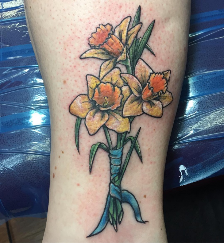 daffodil bouquet tattoo with ribbon