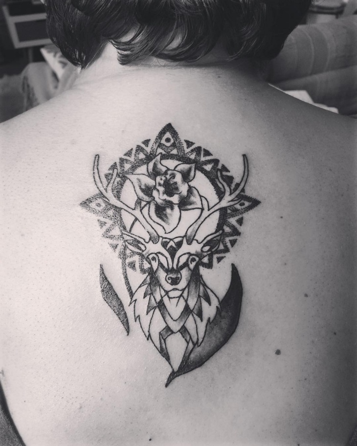 black ink deer tattoo on back