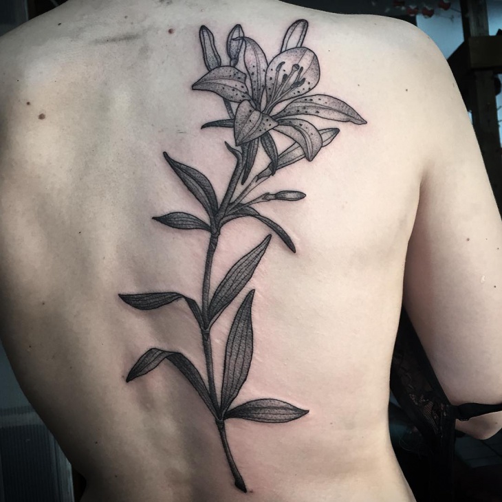 botanical lily tattoo on back