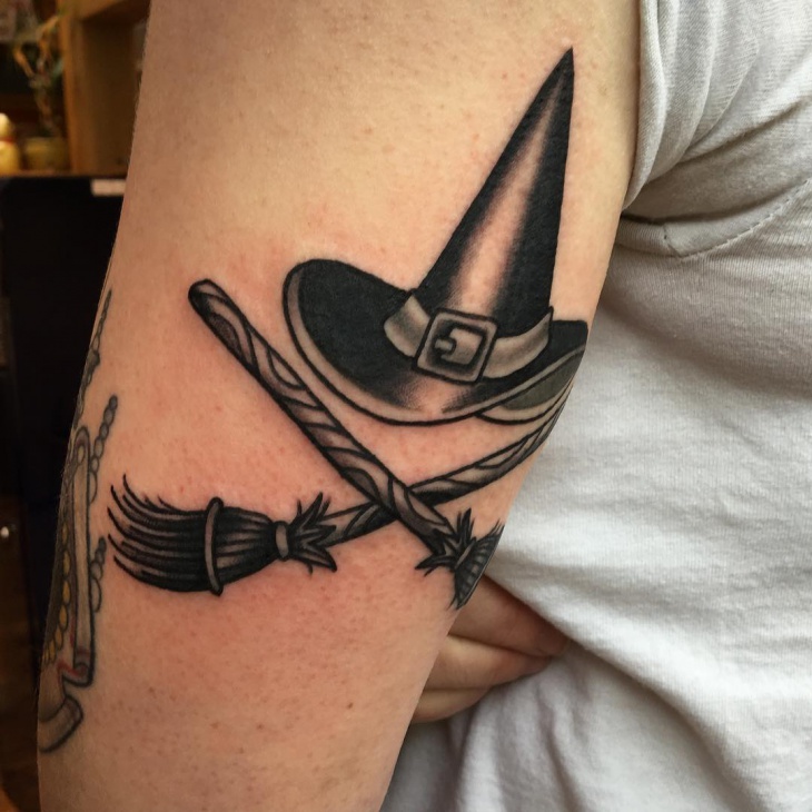 witch hat and broomstick tattoo