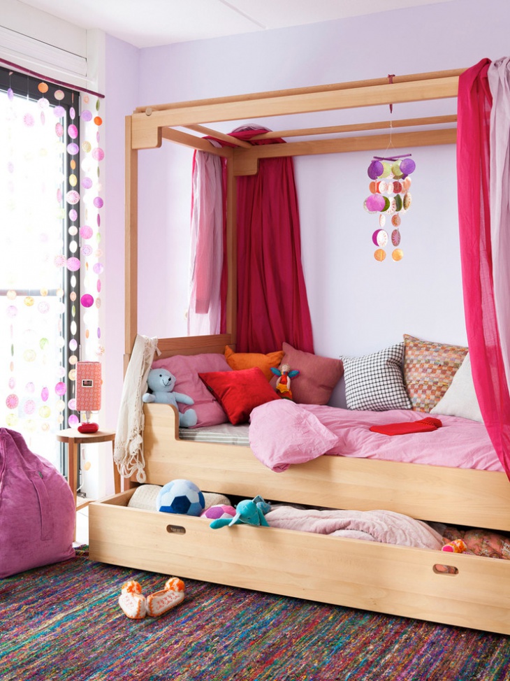 pink canopy bed with storage idea
