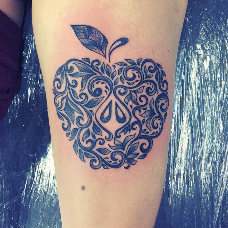 decorative apple tattoo on hand
