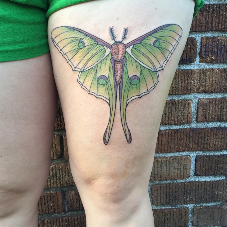 green moth thigh tattoo