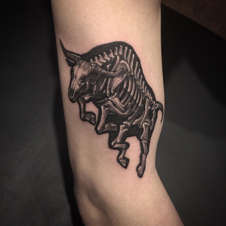black color riding bull tattoo