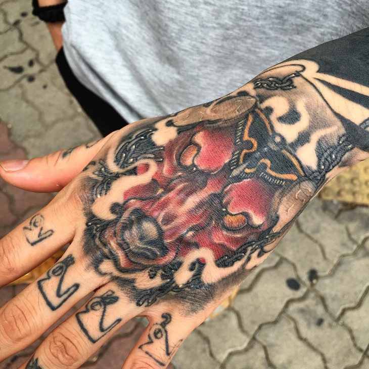 red and black tattoo on palm