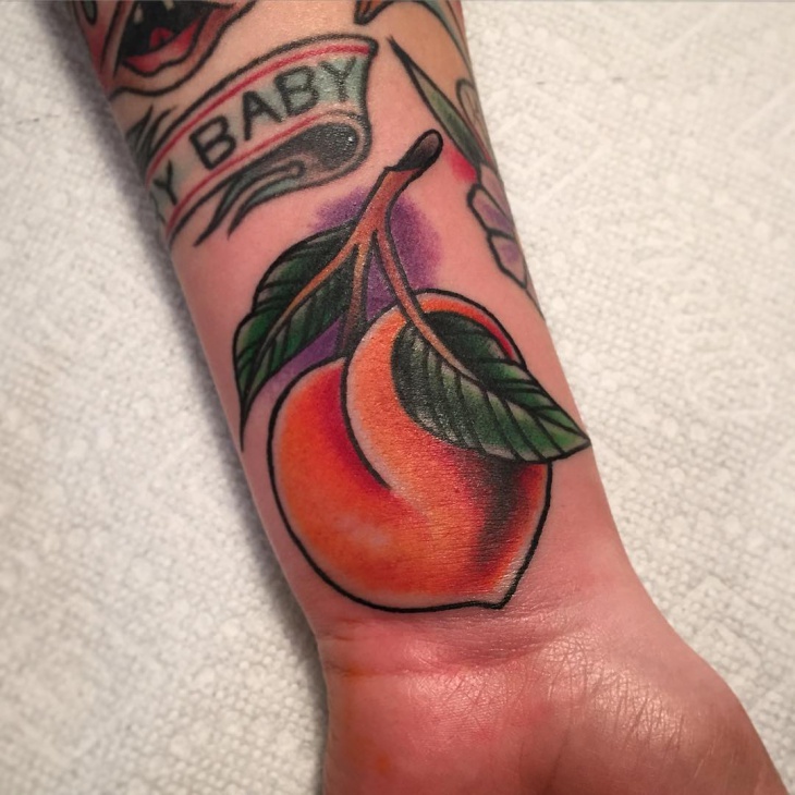 unique peach tattoo on wrist
