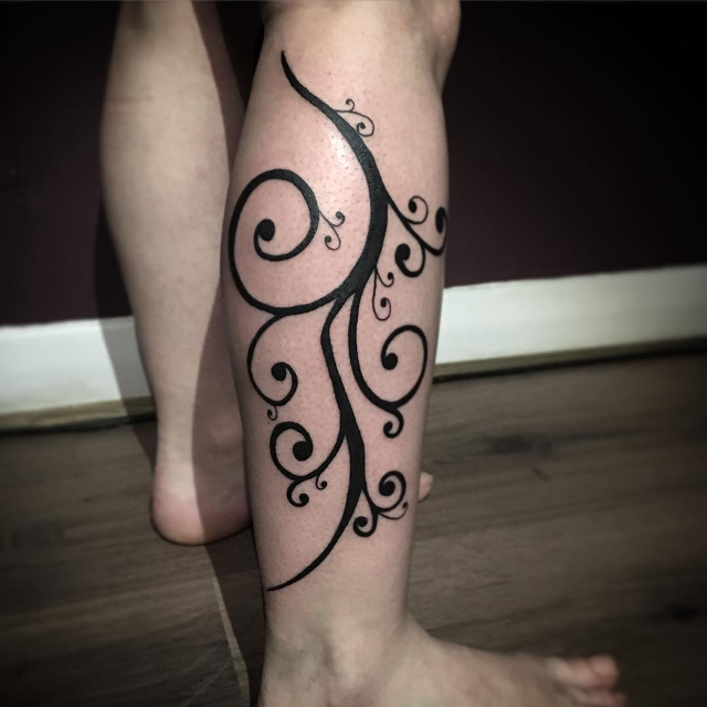 black swirl tattoo for leg