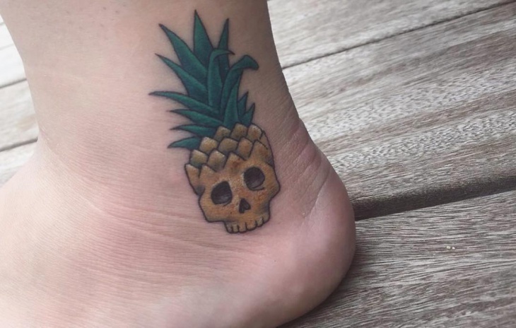 small pineapple skull tattoo on ankle