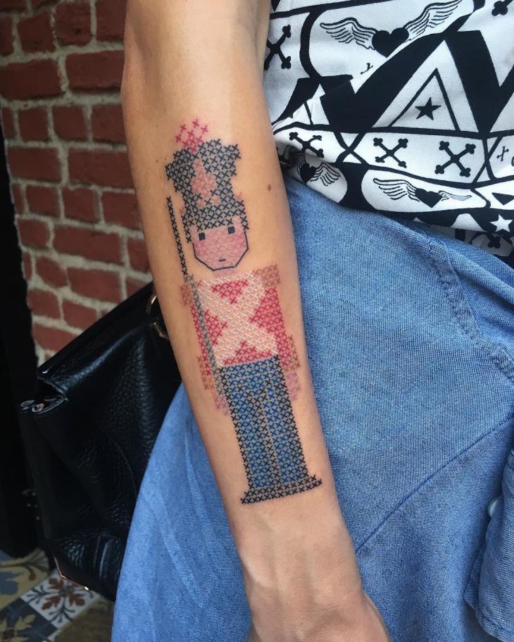 geometric cross stitch tattoo on hand