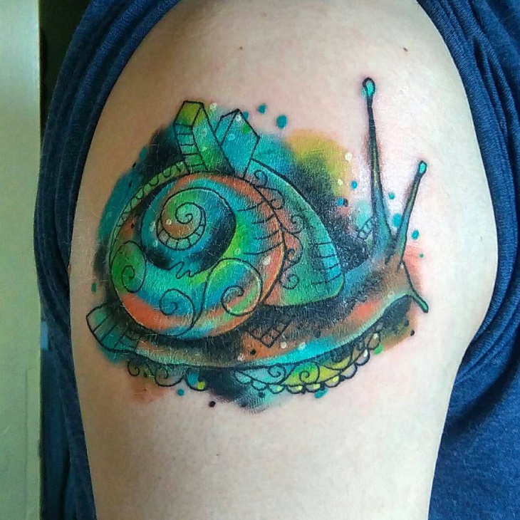 watercolor snail tattoo on shoulder