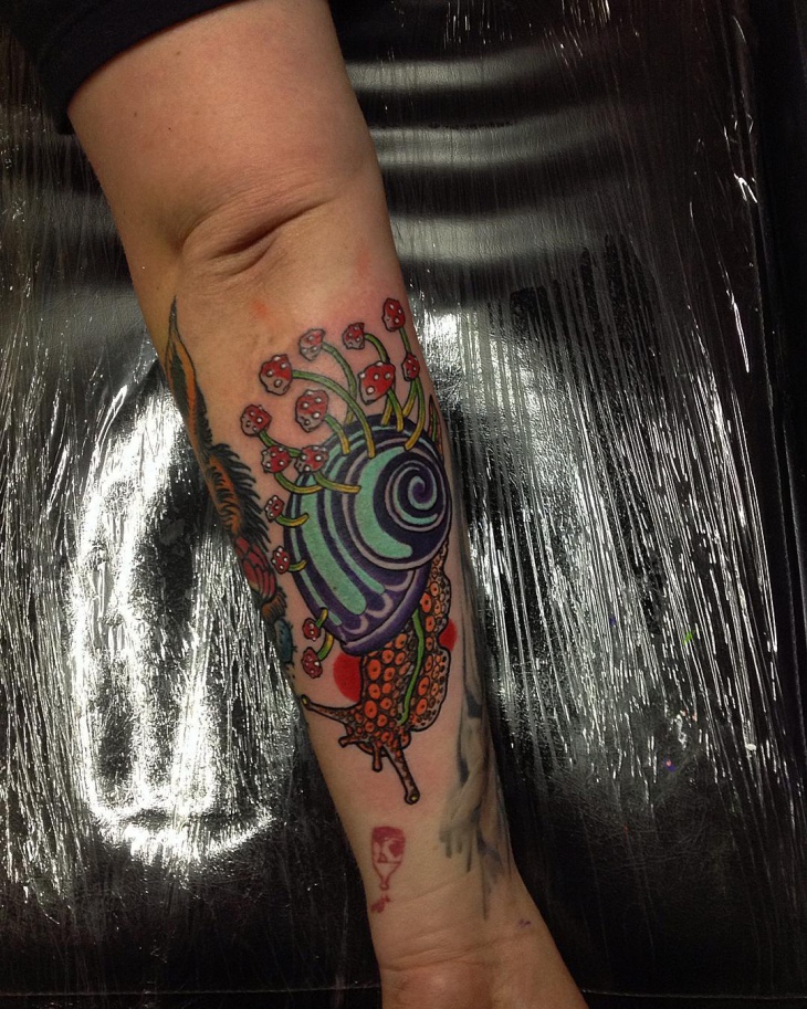 custom snail tattoo on hand