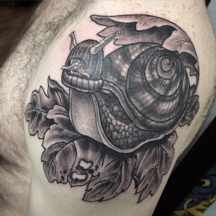 snail tattoo on upperarm