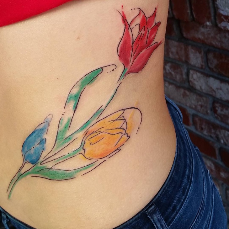 beautiful tulip tattoo on ribs
