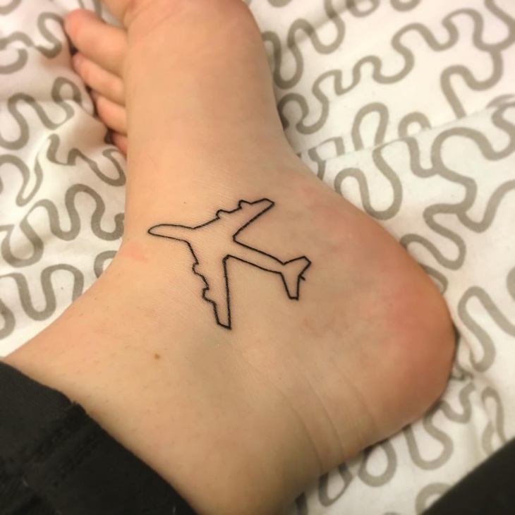 tiny airplane ankle tattoo