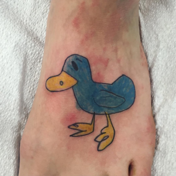 blue duck tattoo on foot