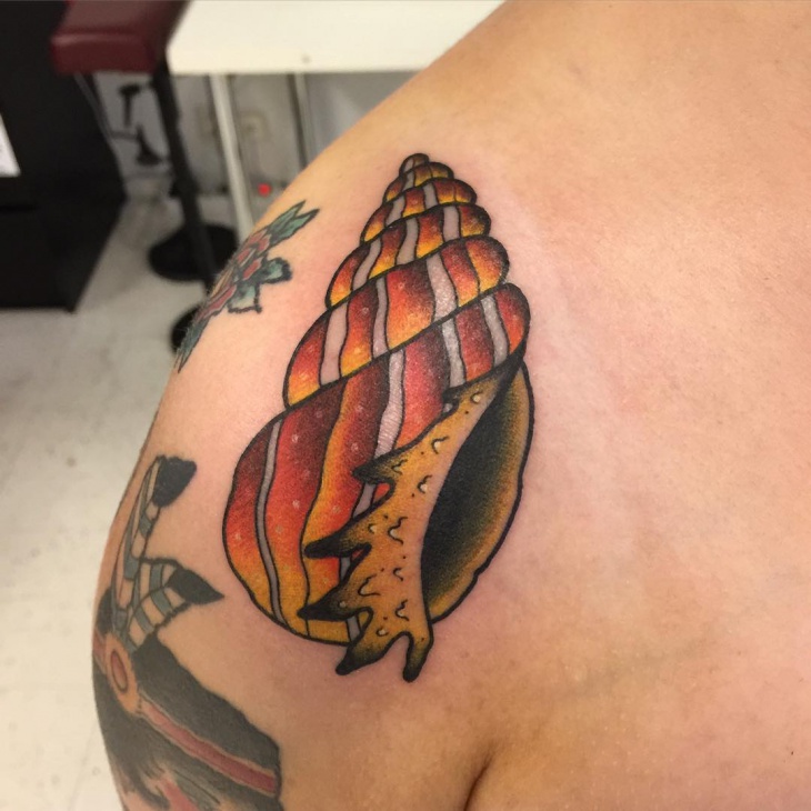 shell tattoo on shoulder