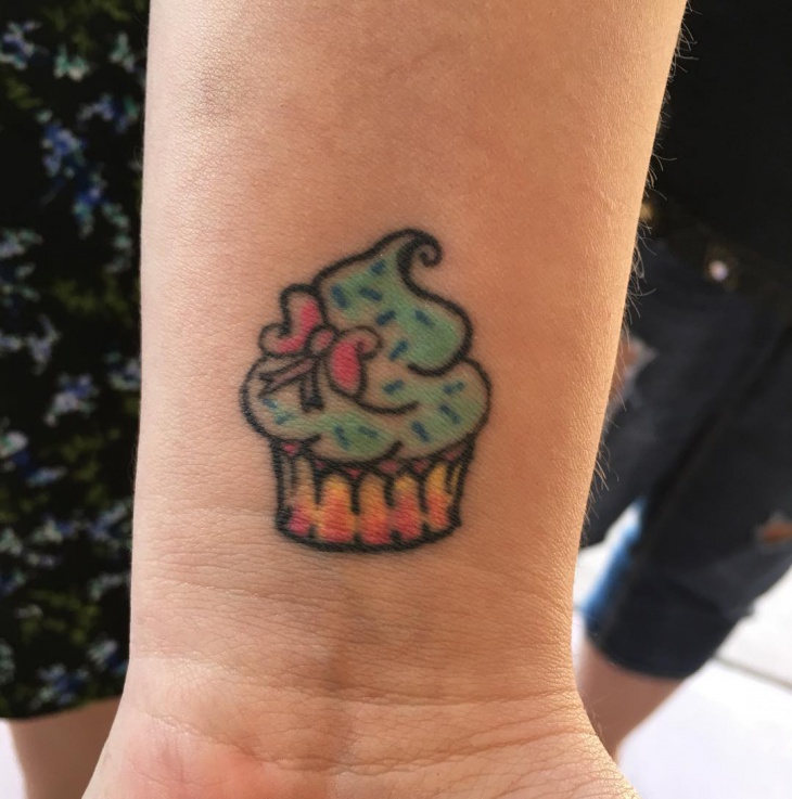 small cupcake tattoo on wrist