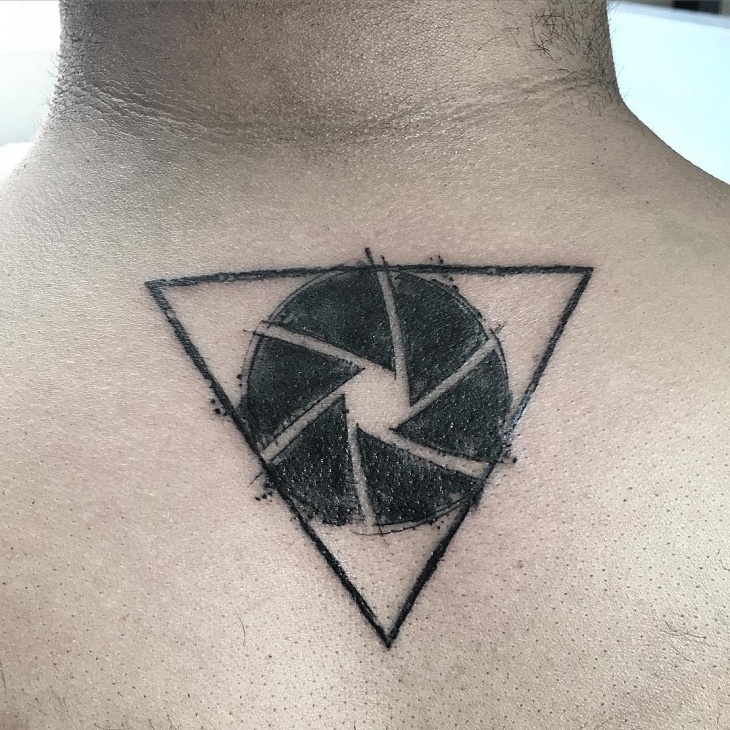 black work tattoo on below neck