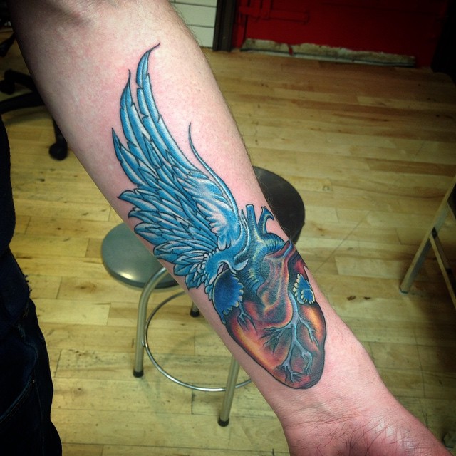 heart with wings tattoo on forearm