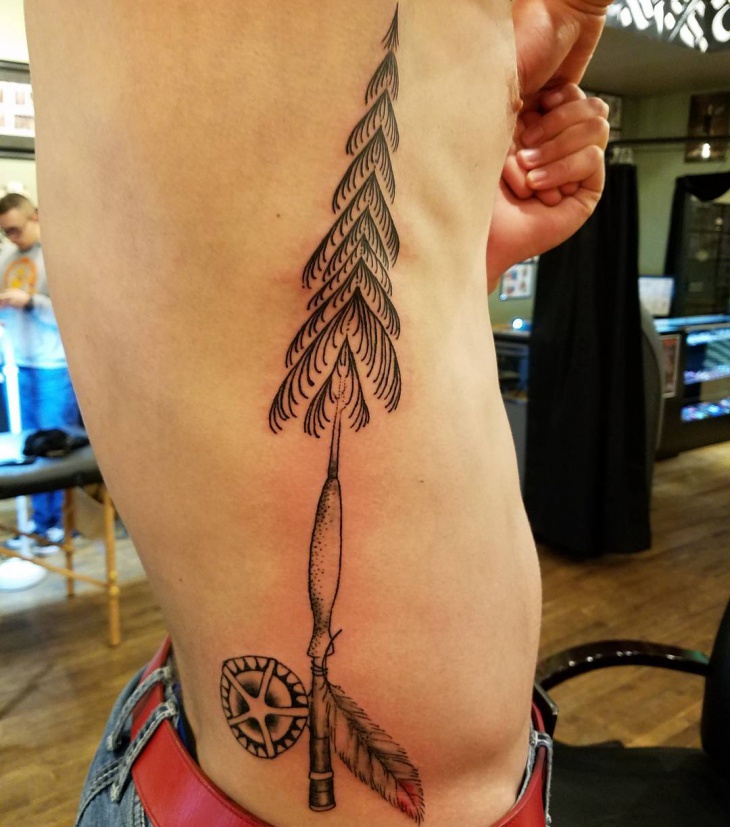 pine tree tattoo on ribs
