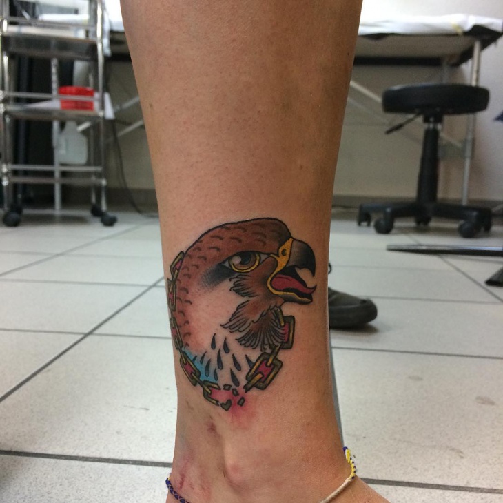 falcon head tattoo on leg