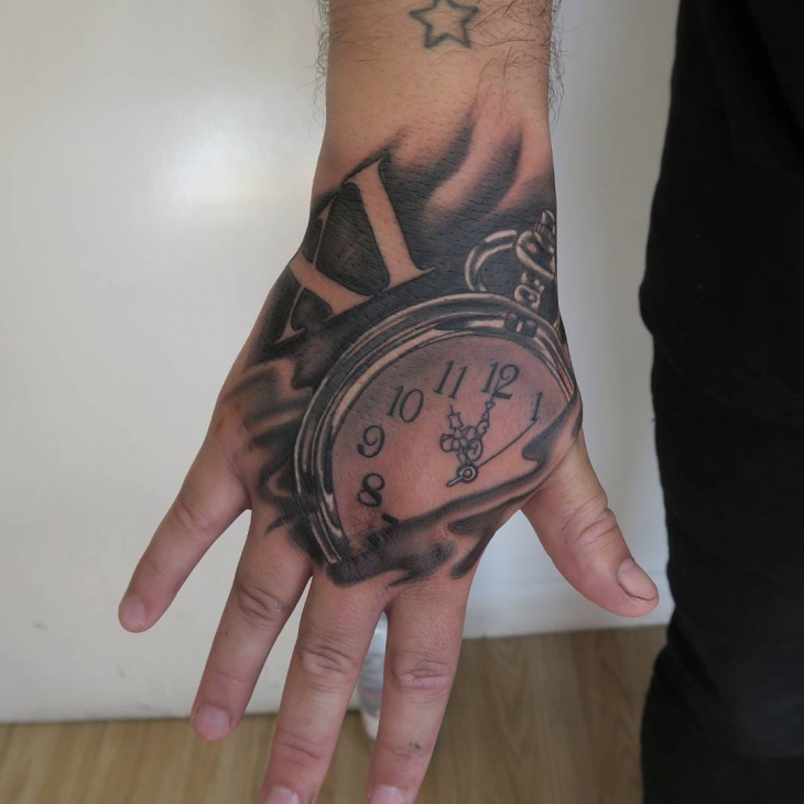 pocket watch tattoo on palm