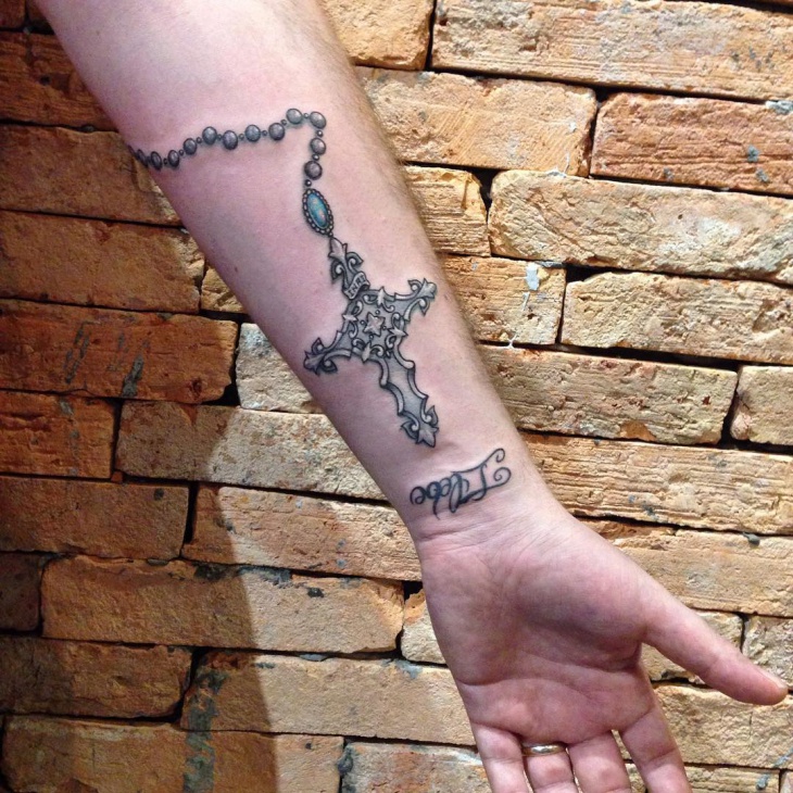 cross forearm tattoo