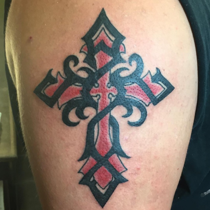 tribal cross arm tattoo