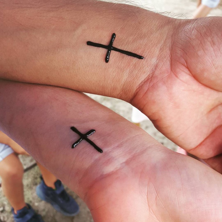 henna cross tattoo on wrist