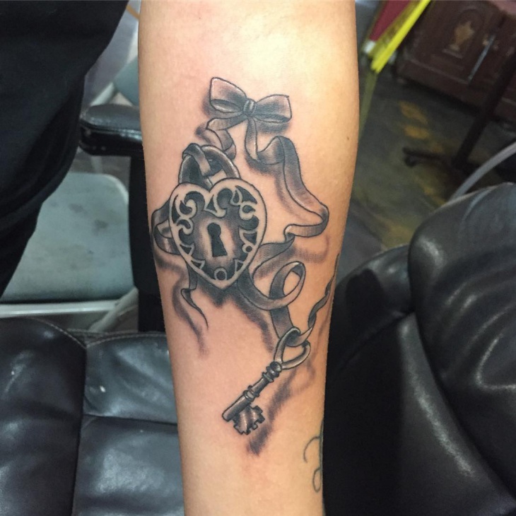 heart locket tattoo on forearm