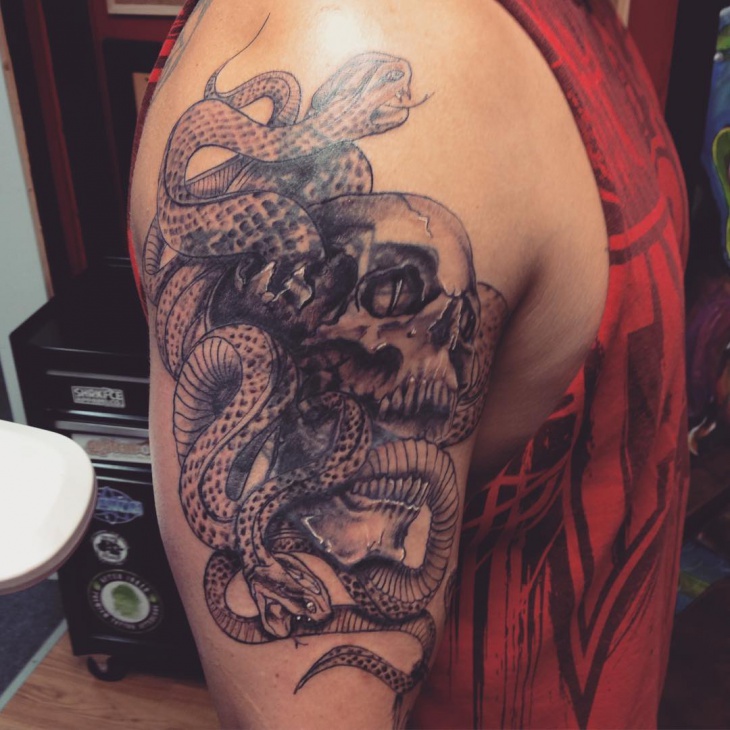 snake with skull sleeve tattoo