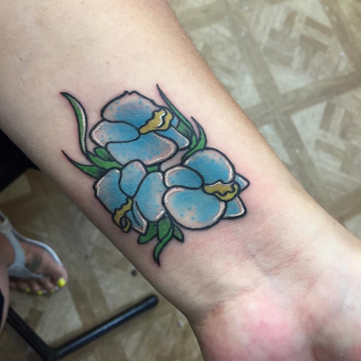small flower wrist tattoo design