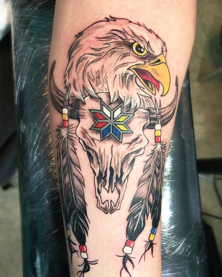 eagle feather with skull tattoo