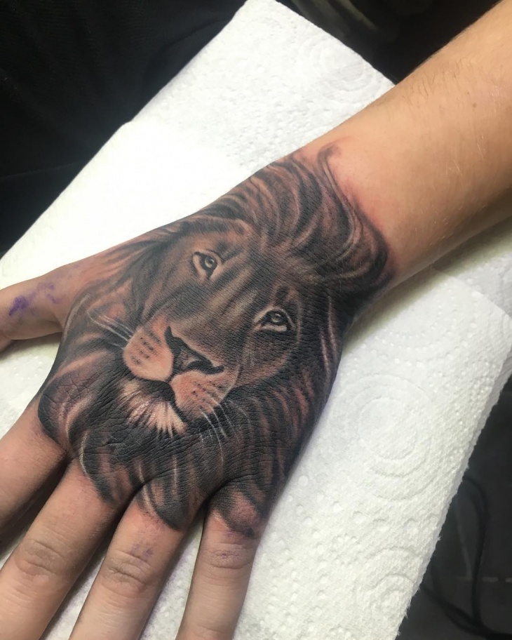 lion face hand tattoo