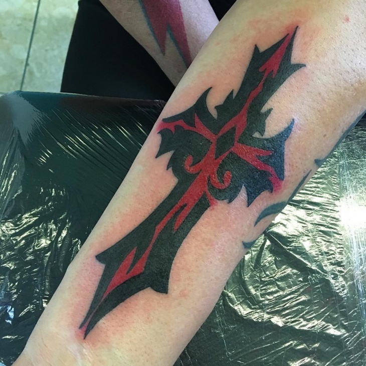 tribal cross forearm tattoo