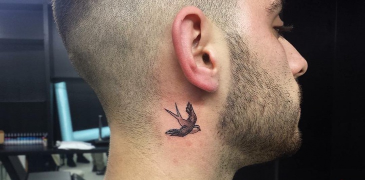 small flying bird tattoo