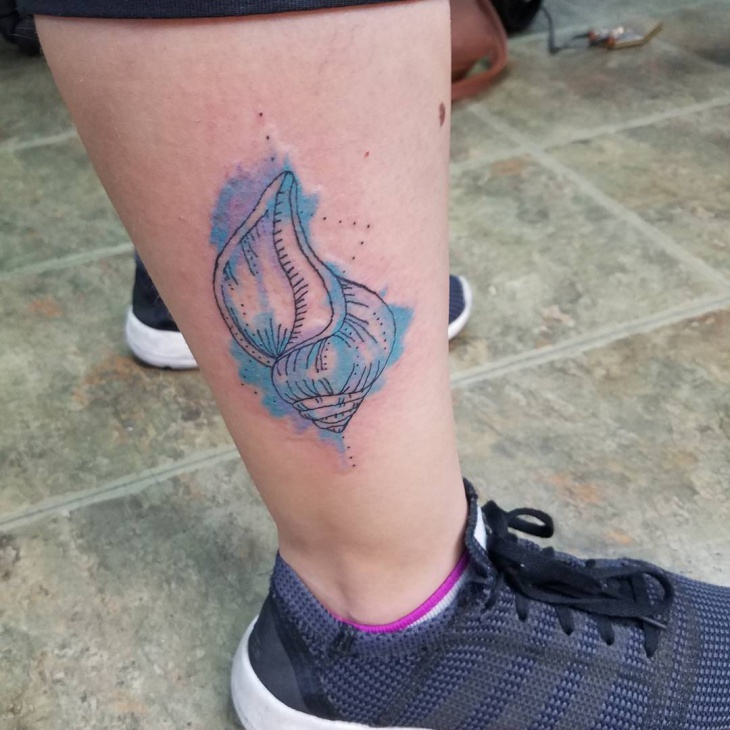 small watercolor tattoo on leg