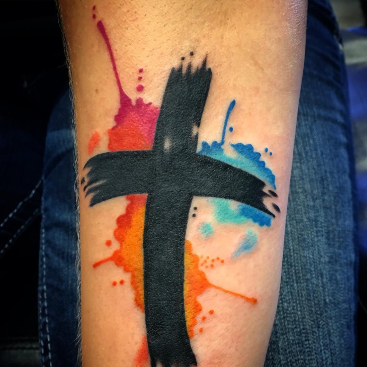 watercolor cross tattoo on hand