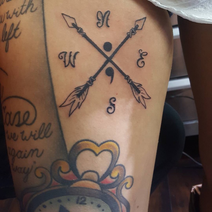semicolon with cross tattoo on thigh