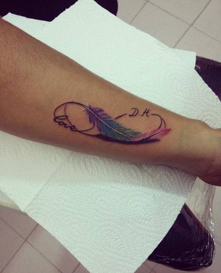 feather side wrist tattoo